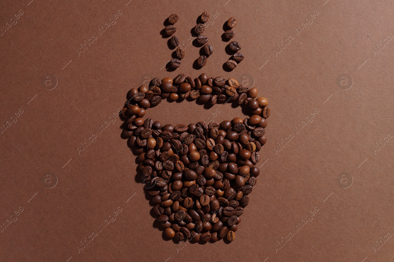 Photo of Cup of hot drink, composition made with coffee beans on brown background, flat lay