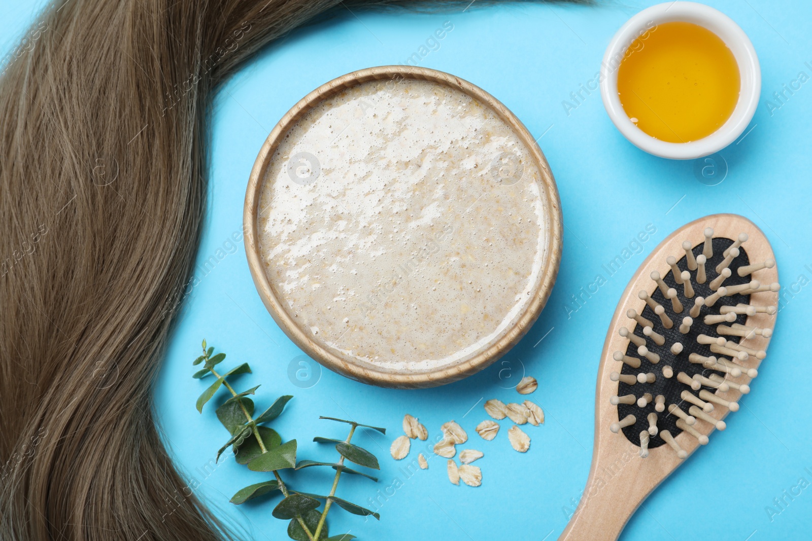 Photo of Flat lay composition with homemade hair mask and ingredients on light blue background