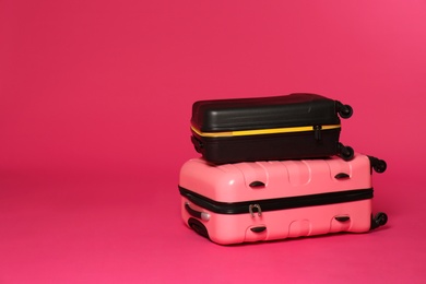 Photo of Stylish suitcases on color background. Space for text
