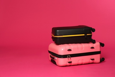 Stylish suitcases on color background. Space for text