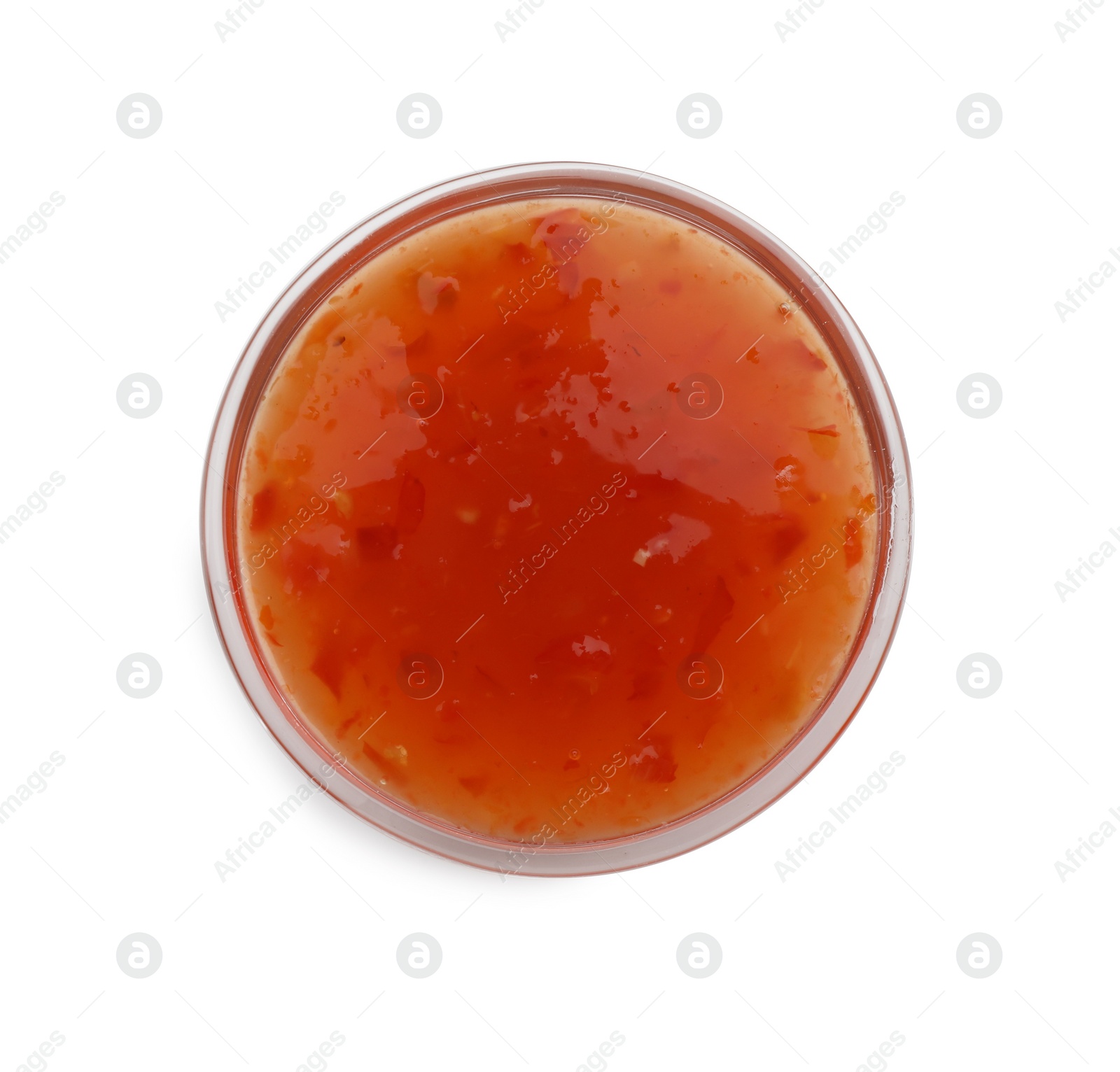 Photo of Tasty chili sauce in bowl isolated on white, top view