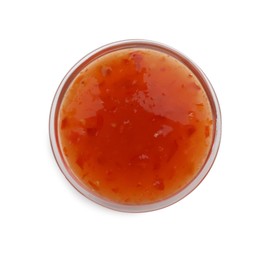 Photo of Tasty chili sauce in bowl isolated on white, top view