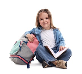 Cute little girl with book and backpack on white background