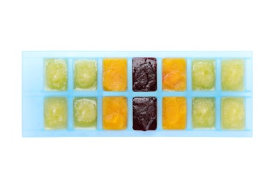 Photo of Different purees in ice cube tray isolated on white, top view. Ready for freezing
