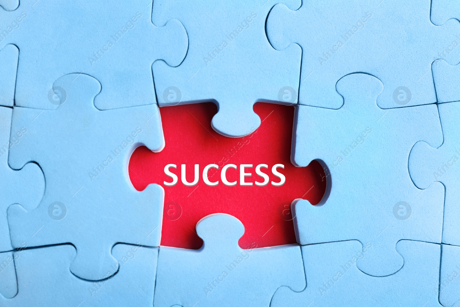 Image of Light blue puzzle with missing piece and word SUCCESS on red background, top view