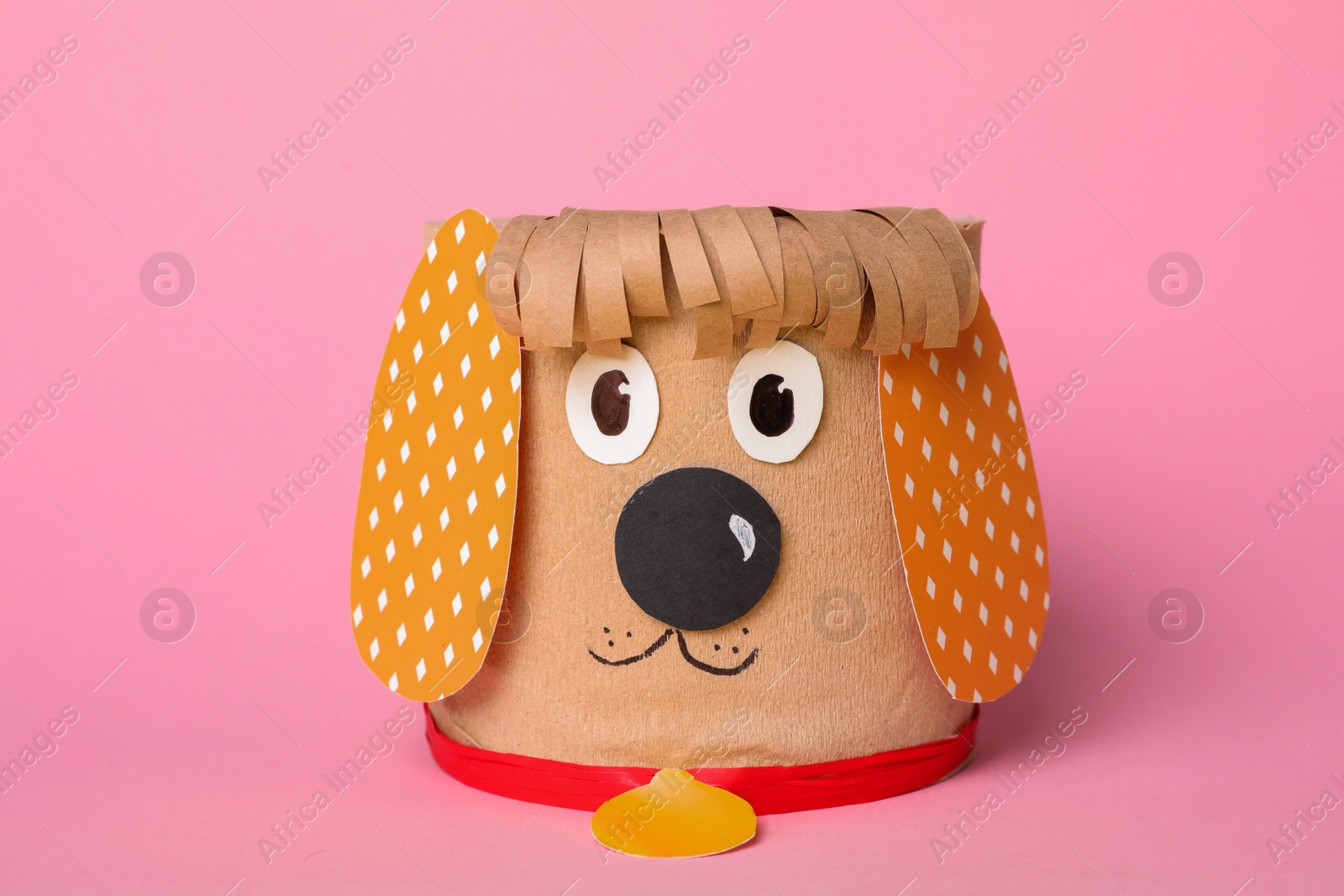 Photo of Toy dog made of toilet paper roll on pink background