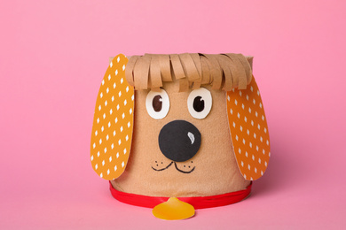 Photo of Toy dog made of toilet paper roll on pink background