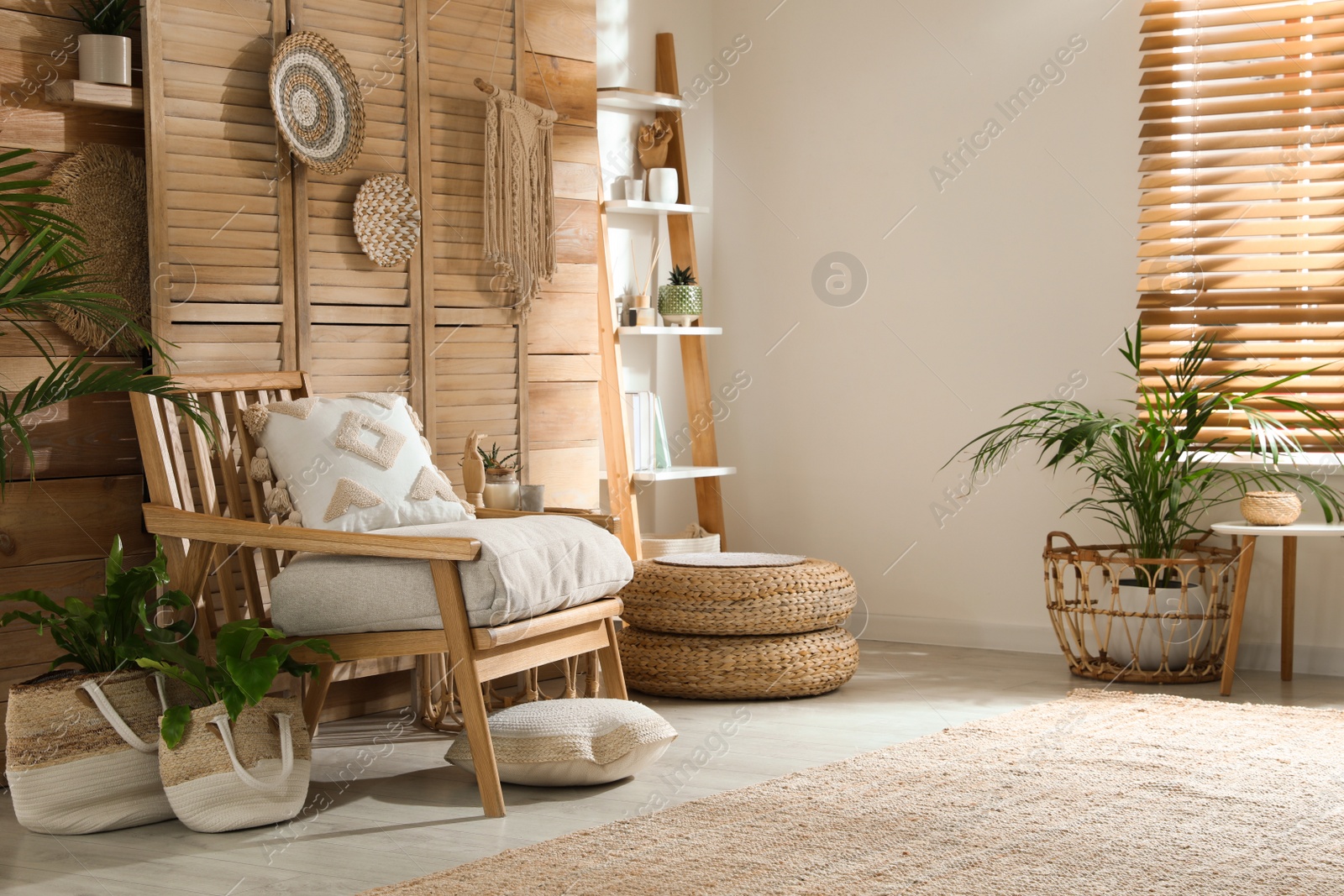 Photo of Stylish living room interior with comfortable wooden armchair and beautiful houseplants