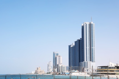 AJMAN, UNITED ARAB EMIRATES - NOVEMBER 04, 2018: Landscape with modern skyscrapers on sunny day