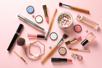 Photo of Flat lay composition with products for decorative makeup on pastel pink background