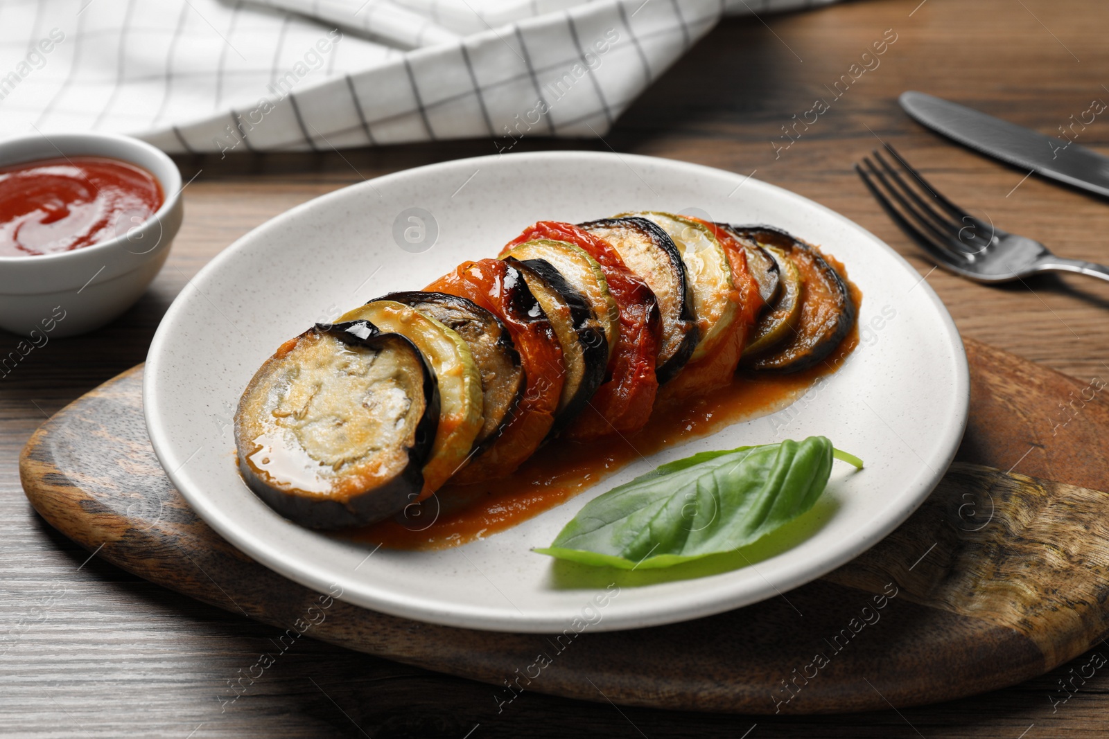 Photo of Fresh delicious ratatouille served on wooden table