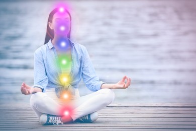 Image of Young woman meditating near river. Scheme of seven chakras, illustration