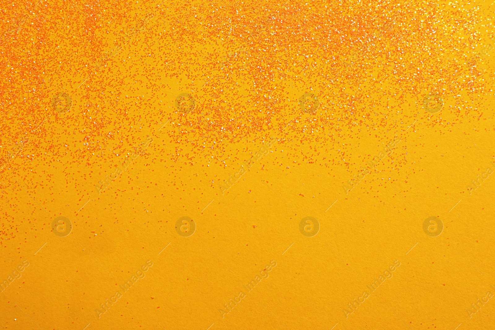 Photo of Shiny bright glitter on yellow background, flat lay. Space for text