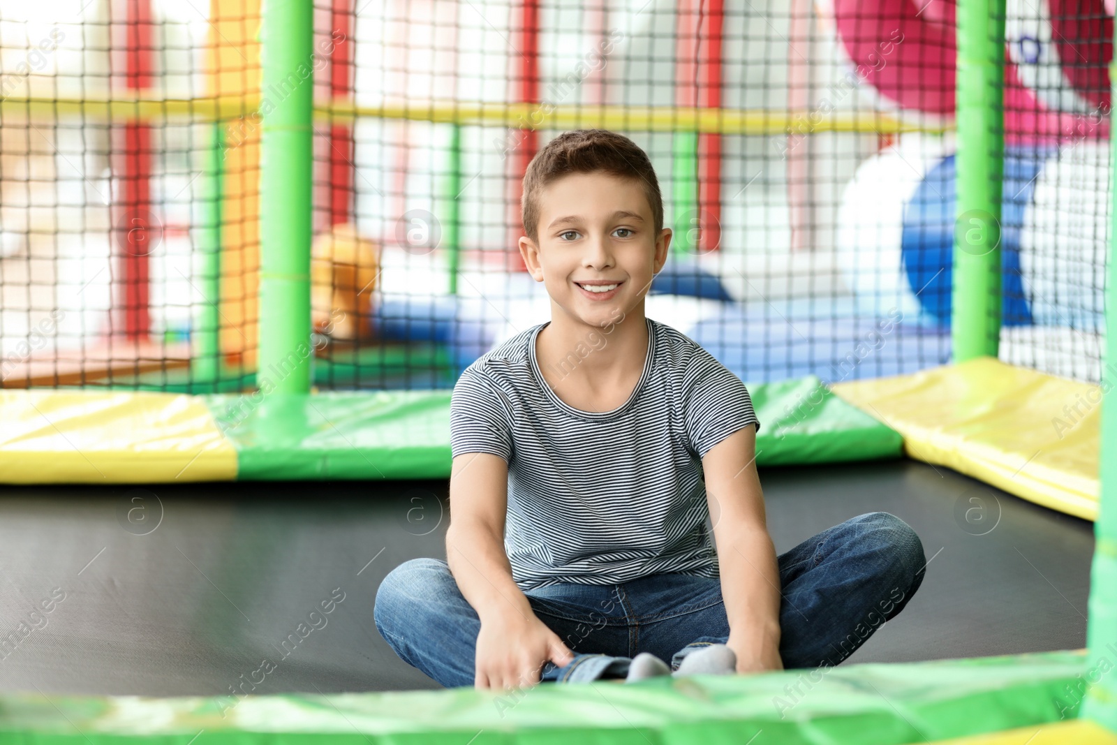 Photo of Cute little child playing at indoor amusement park