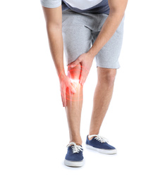 Man suffering from knee pain on white background, closeup