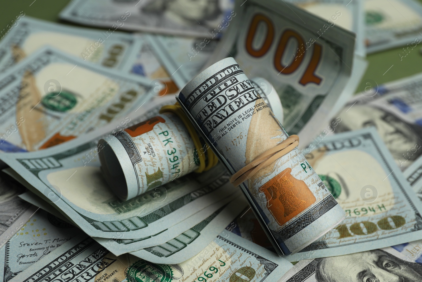 Photo of Money exchange. Dollar banknotes on table, closeup