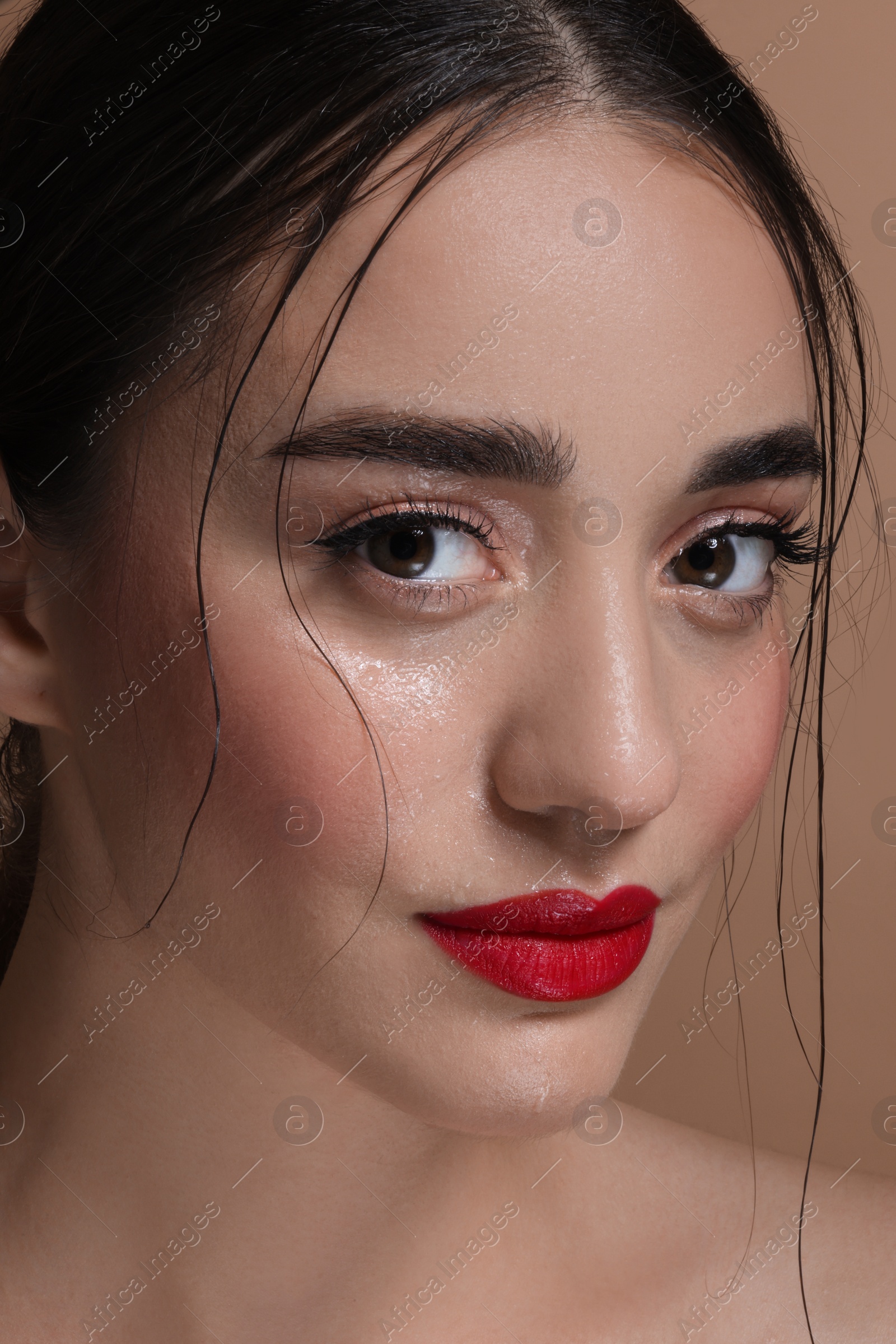 Photo of Portrait of beautiful young woman with red lips, closeup