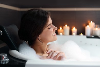 Photo of Happy beautiful woman taking bubble bath. Romantic atmosphere