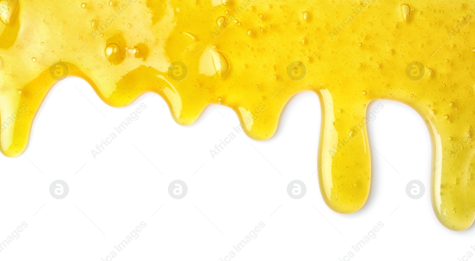 Photo of Flowing yellow slime on white background. Antistress toy