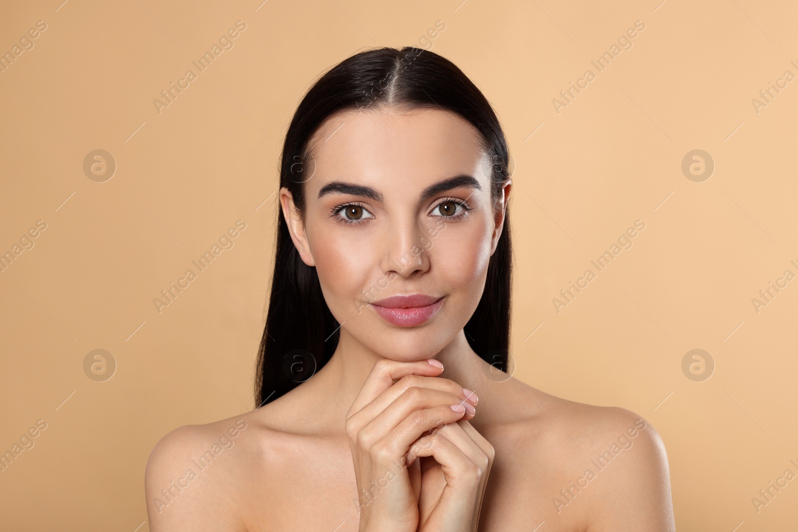 Photo of Portrait of attractive young woman on beige background. Spa treatment