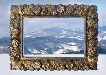 Image of Vintage frame and beautiful mountains covered with snow in winter