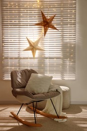 Photo of Beautiful decorative stars and festive lights in room. Christmas atmosphere