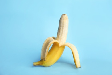Photo of Fresh banana on light blue background. Sex concept