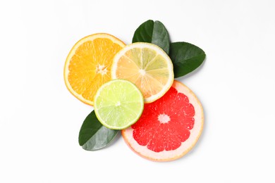 Photo of Slices of fresh ripe citrus fruits and green leaves on white background, flat lay