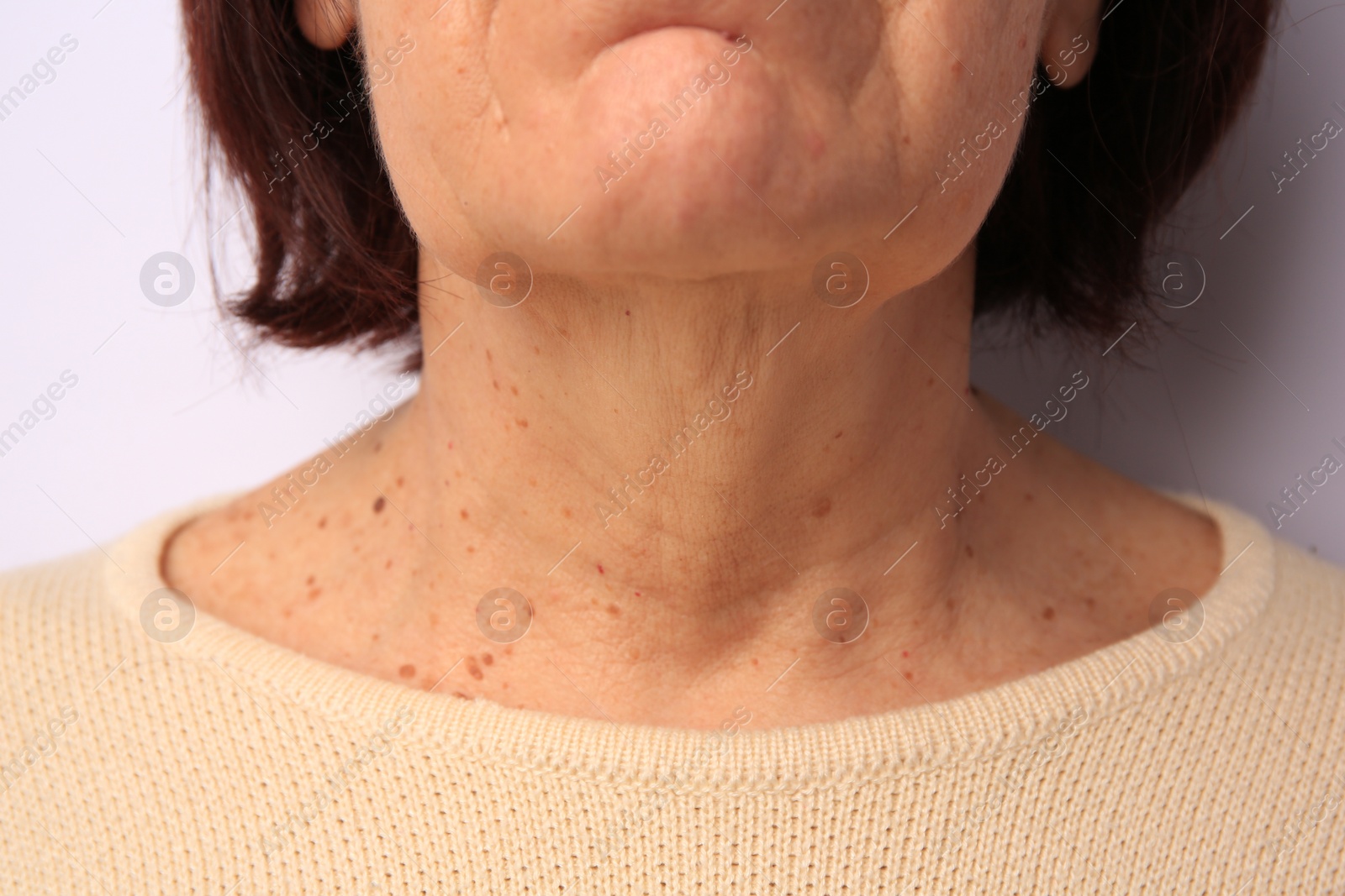 Photo of Closeup view of older woman on white background