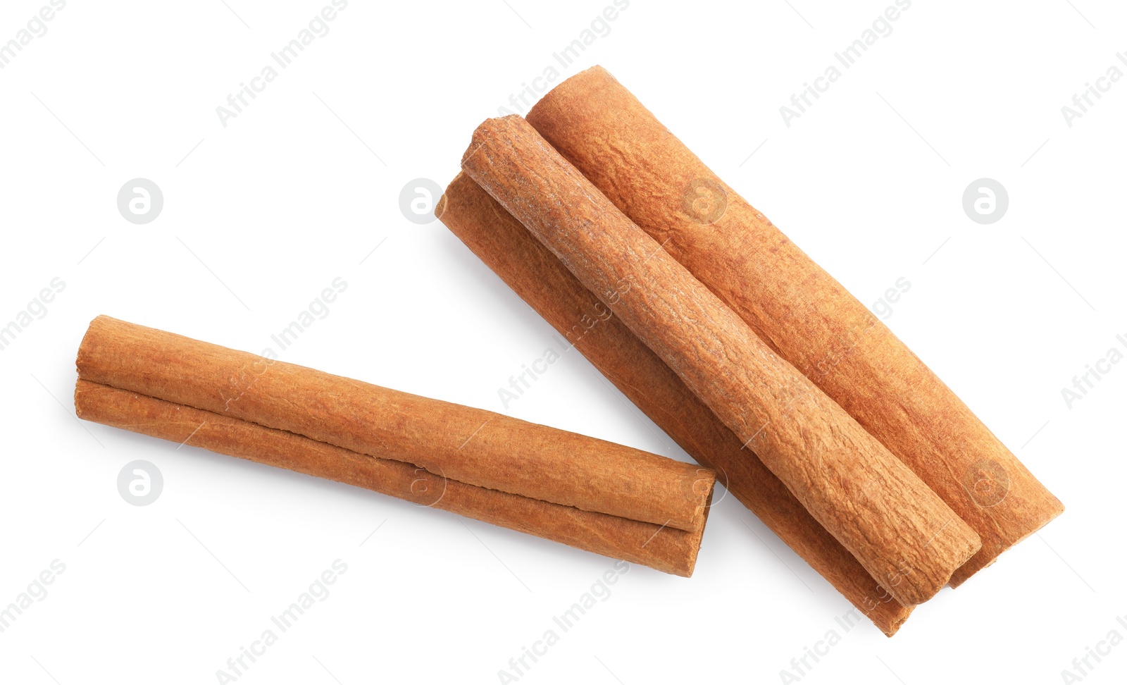 Photo of Pile of aromatic cinnamon sticks isolated on white, top view