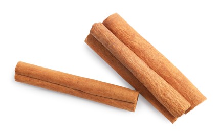 Photo of Pile of aromatic cinnamon sticks isolated on white, top view
