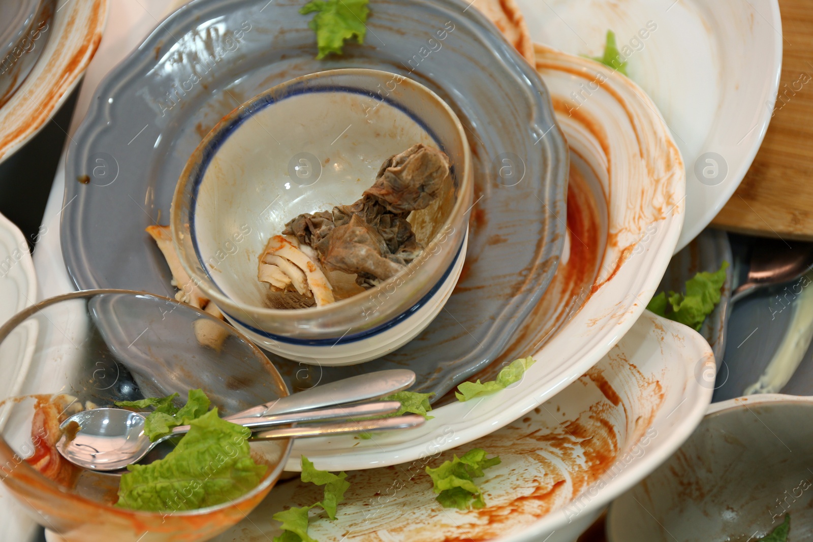 Photo of Many dirty dishes, closeup. Mess after new year party