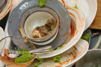 Photo of Many dirty dishes, closeup. Mess after new year party