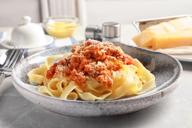 Photo of Plate with delicious pasta bolognese on table