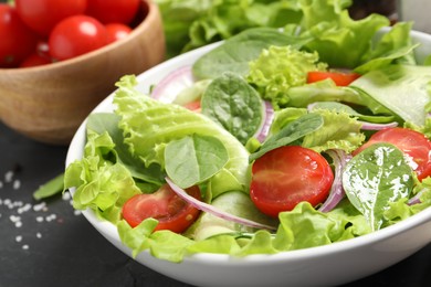 Photo of Delicious vegetable salad on grey table, closeup
