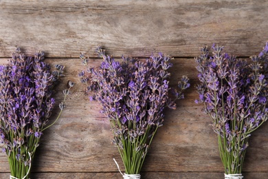 Photo of Flat lay composition with lavender flowers on wooden background