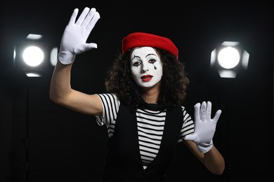 Young woman in mime costume performing on stage