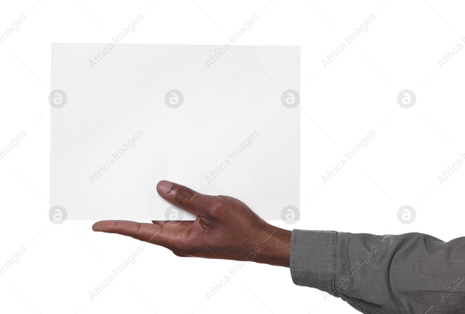 Photo of African American man holding sheet of paper on white background, closeup. Mockup for design