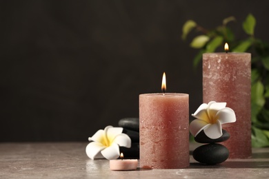Photo of Composition with candles and spa stones on marble table. Space for text