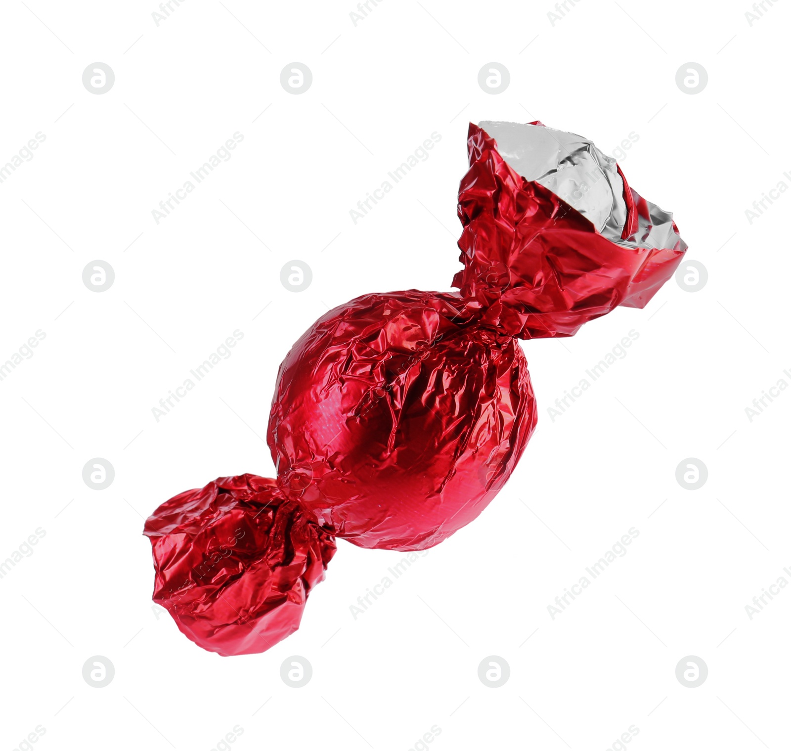 Photo of Tasty candy in red wrapper isolated on white