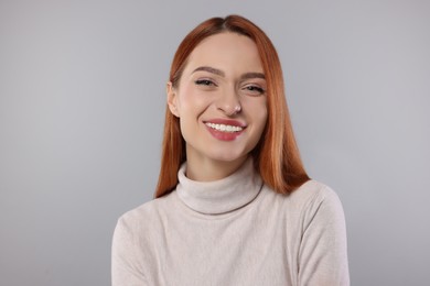 Portrait of beautiful young woman on light gray background
