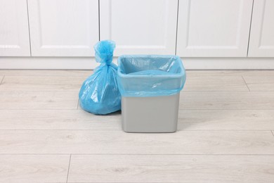 Photo of Plastic garbage bag and trash can indoors