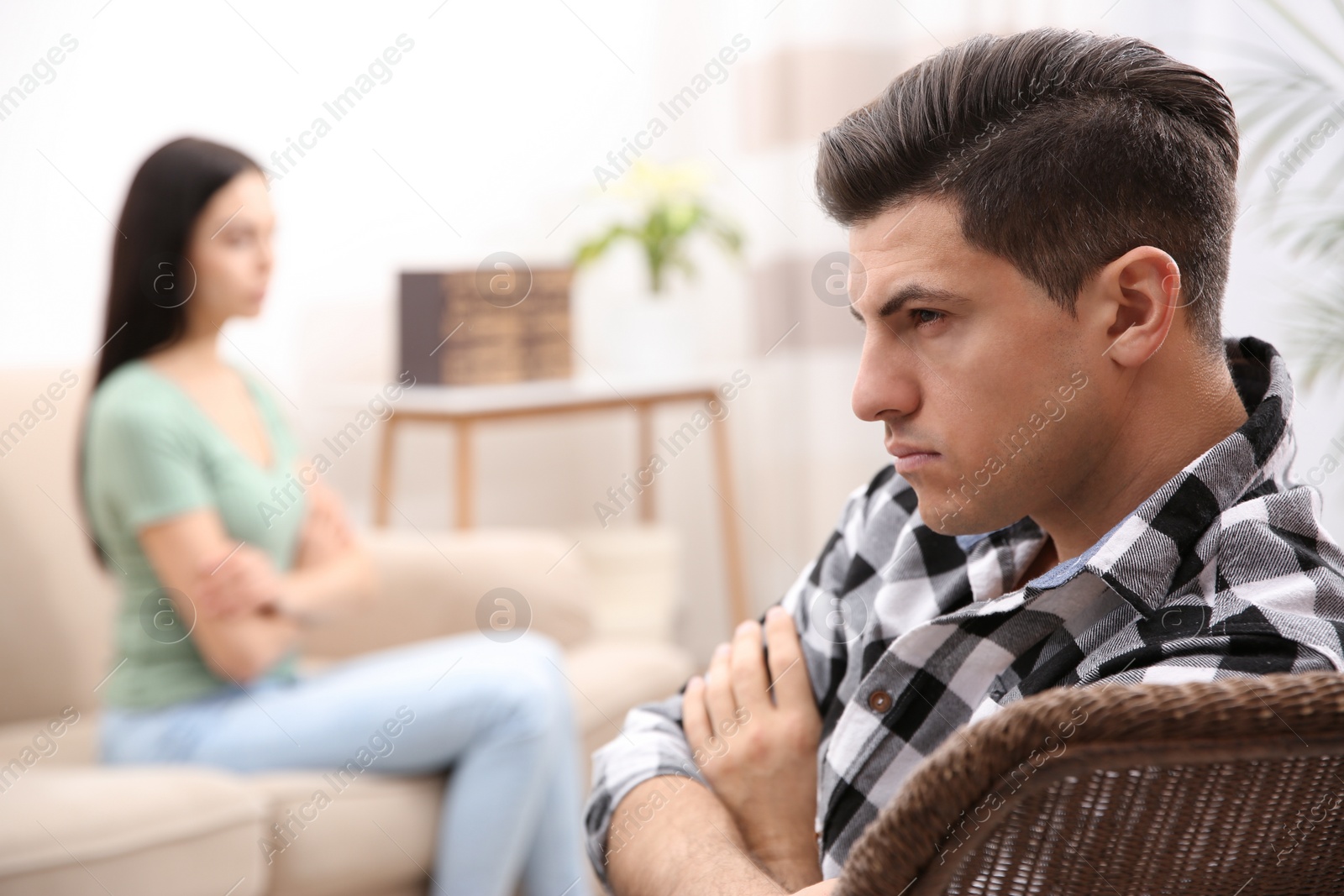 Photo of Unhappy man after quarrel with his girlfriend indoors. Relationship problems