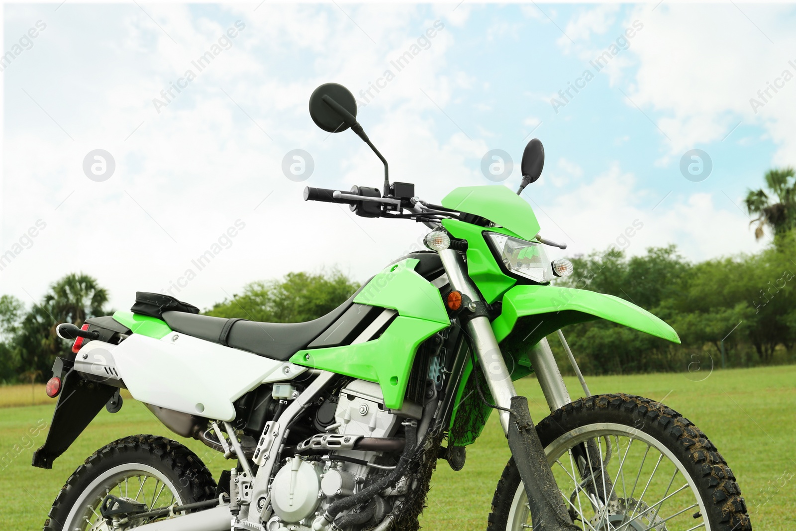 Photo of Green stylish cross motorcycle on grass outdoors