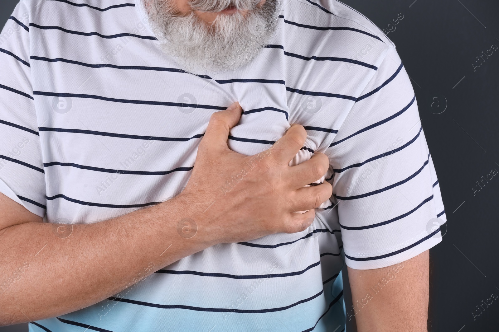 Photo of Mature man having heart attack, closeup