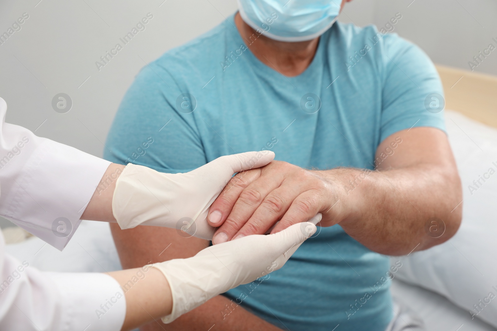 Photo of Doctor taking care of senior man with protective mask at nursing home, closeup