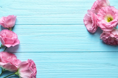 Photo of Flat lay composition with beautiful Eustoma flowers on wooden background