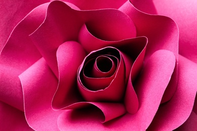 Photo of Beautiful red flower made of paper as background, top view