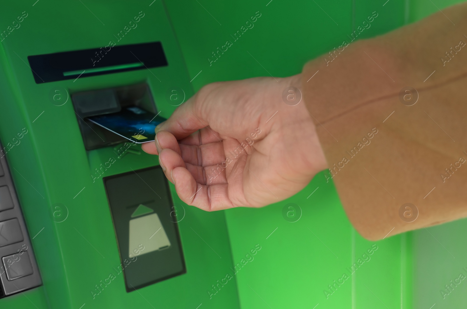 Photo of Man with debit card using modern cash machine, closeup of hand