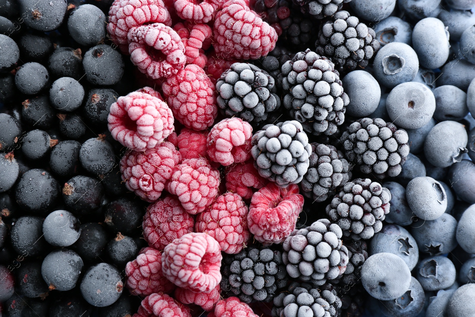 Photo of Mix of different frozen berries as background, top view